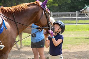 Camp Runoia camper loves horse riding